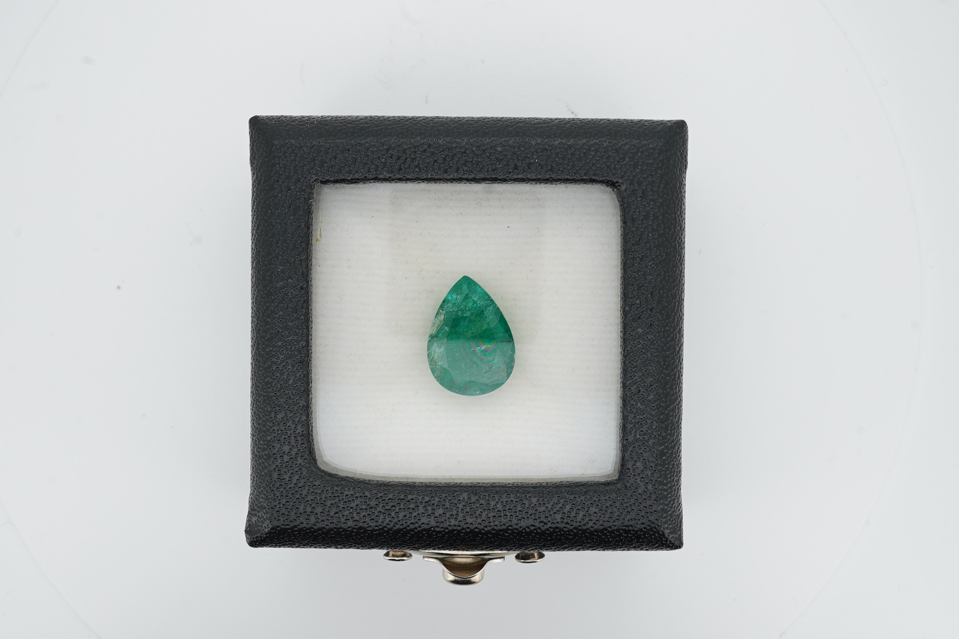 An unmounted pear cut emerald, weighing 6.32ct. Condition - poor to fair